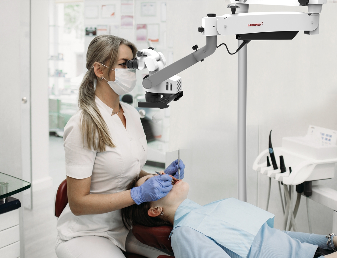 Doctor making teeth examination research survey using microscope in dentistry. Dentist is treating patient in modern dental office. lite DNT Brhandlerin-2