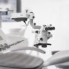 Interior of dental practice room with chair, lamp, display and stomatological tools Interior,Of,Dental,Practice,Room,With,Chair,,Lamp,,Display,And