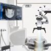 Interior of dental practice room with close up on microscope and dental scan on the display. Stomatology modern equipment Interior,Of,Dental,Practice,Room,With,Close,Up,On,Microscope