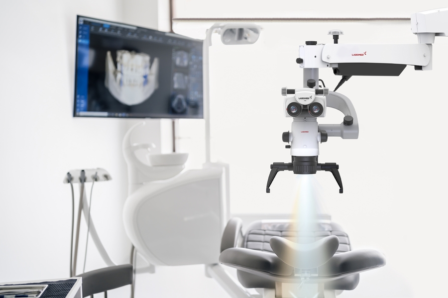 Interior of dental practice room with close up on microscope and dental scan on the display. Stomatology modern equipment Interior,Of,Dental,Practice,Room,With,Close,Up,On,Microscope