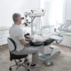 Dentist using dental microscope treating patient teeth at dental clinic office. Medicine, dentistry and health care concept. Dental equipment Dentist,Using,Dental,Microscope,Treating,Patient,Teeth,At,Dental,Clinic